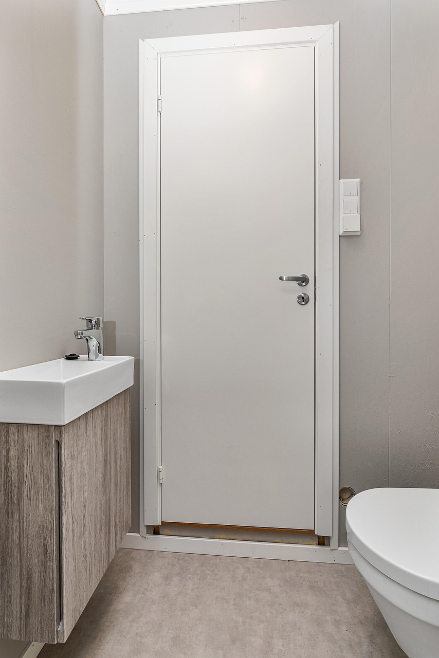 Calm bathroom styled with neatly folded towels and simple accessories