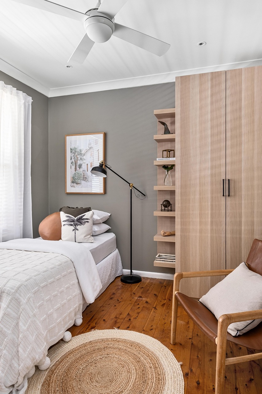 Bedroom with warm wood furniture and soft layered lighting from bedside lamps
