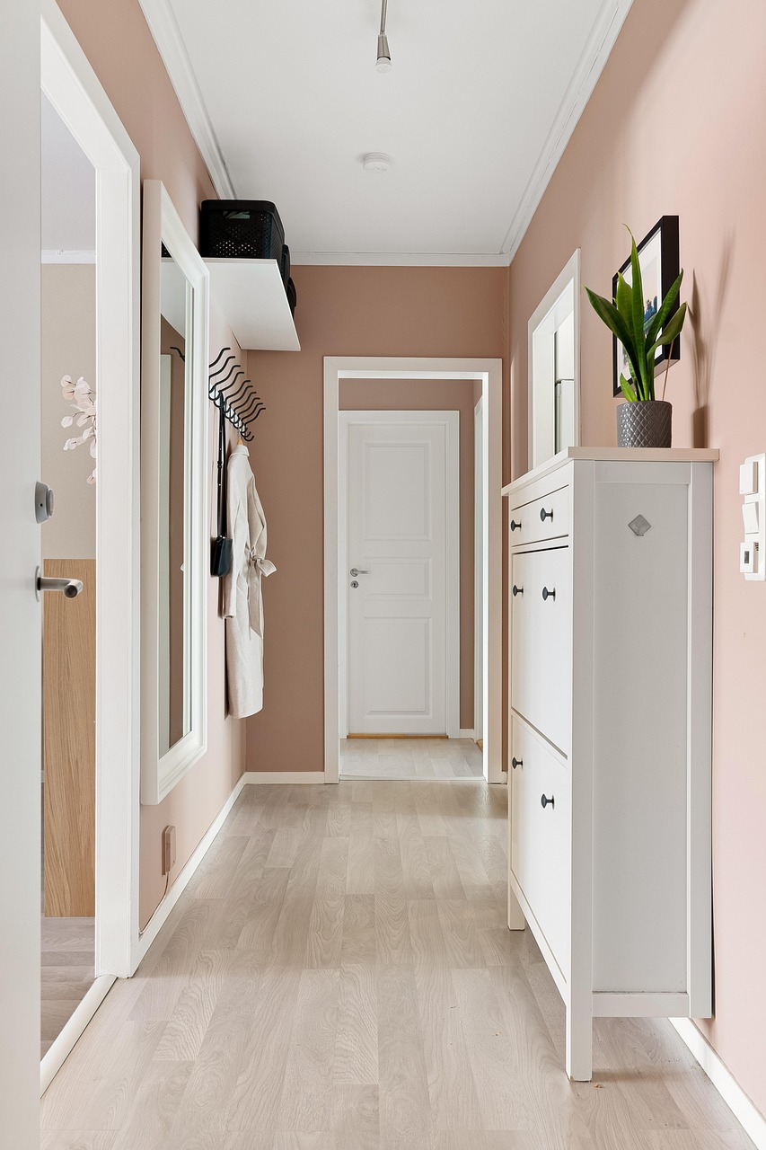 Welcoming entryway with a slim bench, hooks and warm lighting