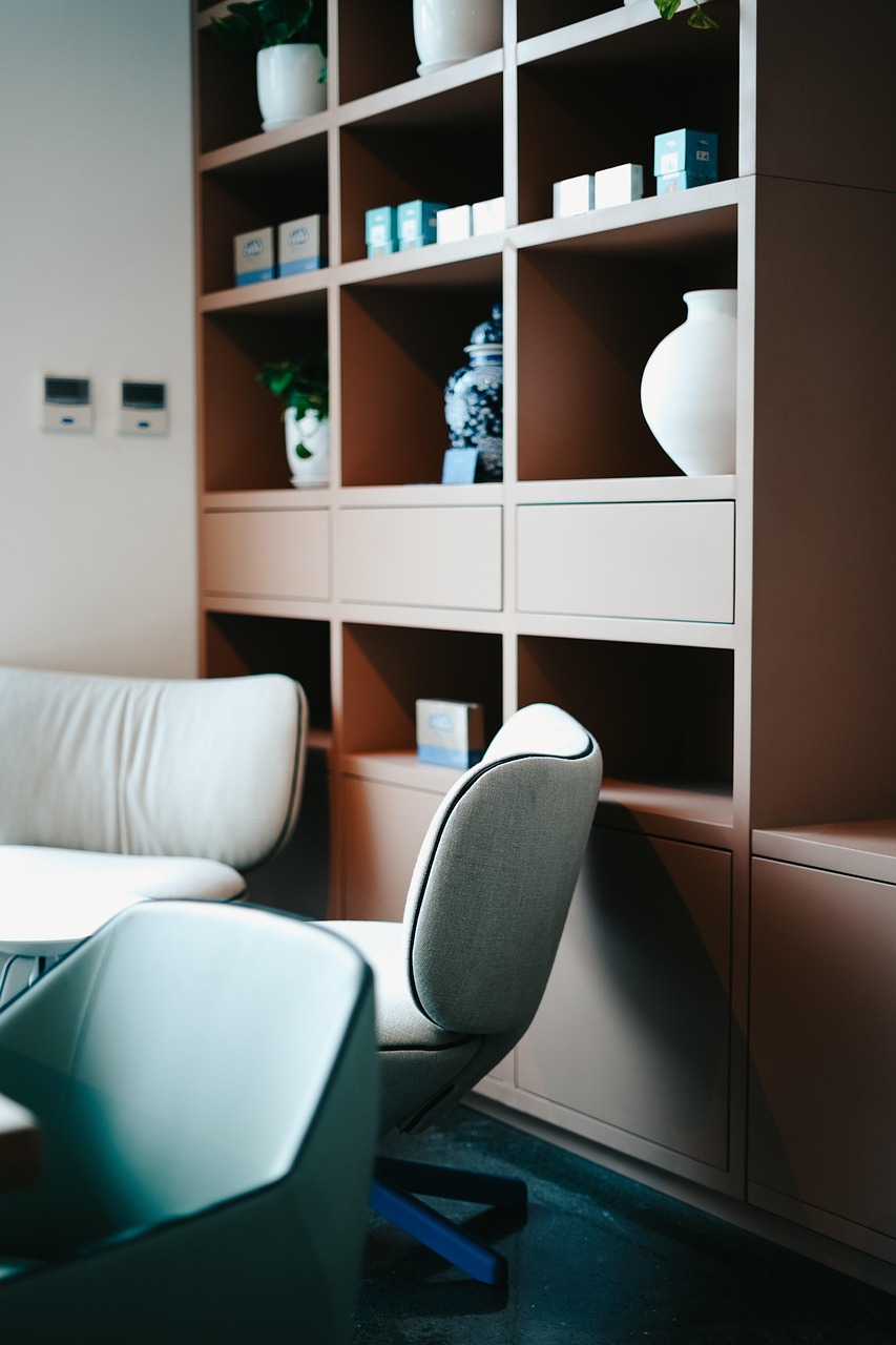 Desk paired with wall shelves and a comfortable upholstered chair