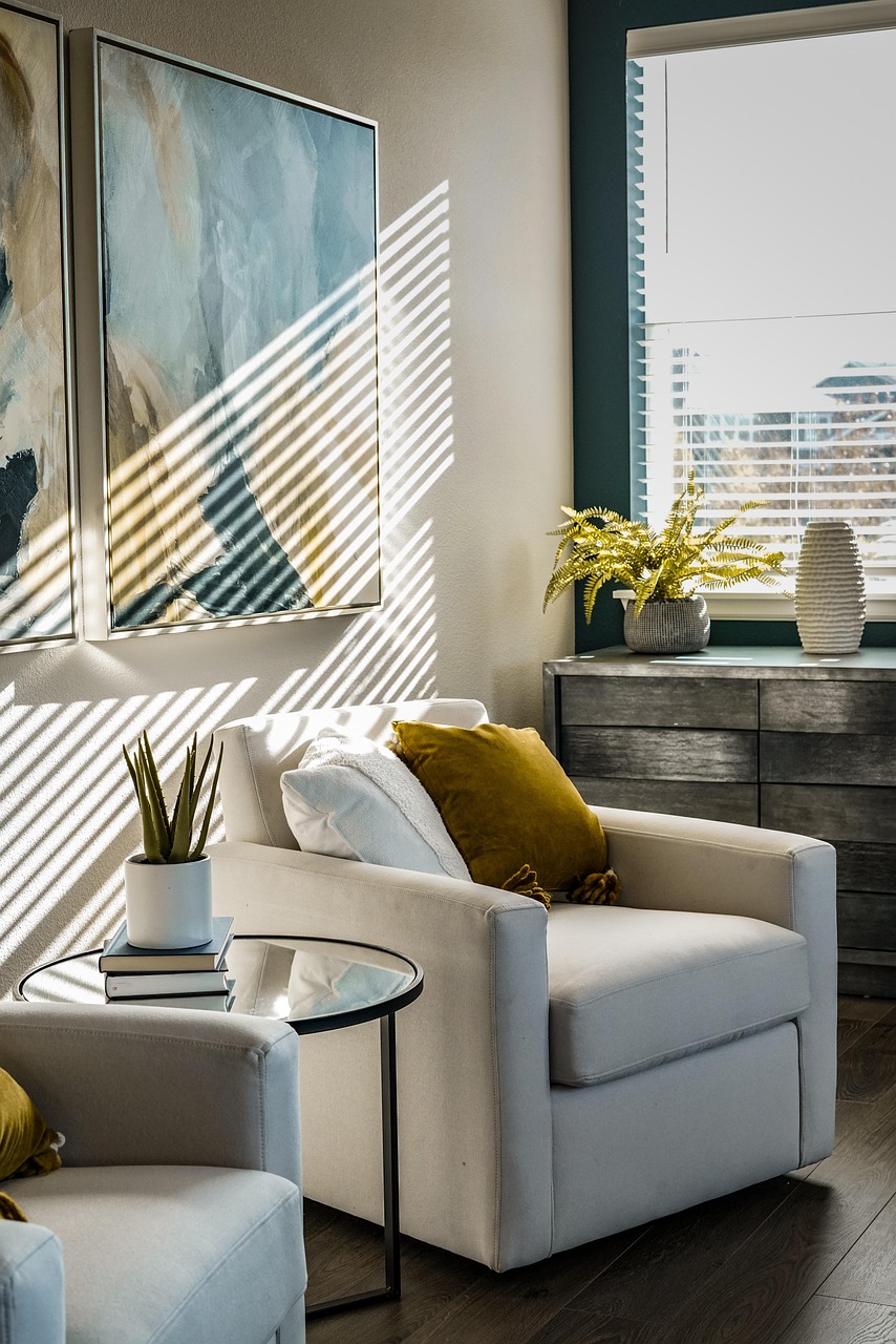 Cozy living room corner with layered cushions, a plant and warm afternoon light