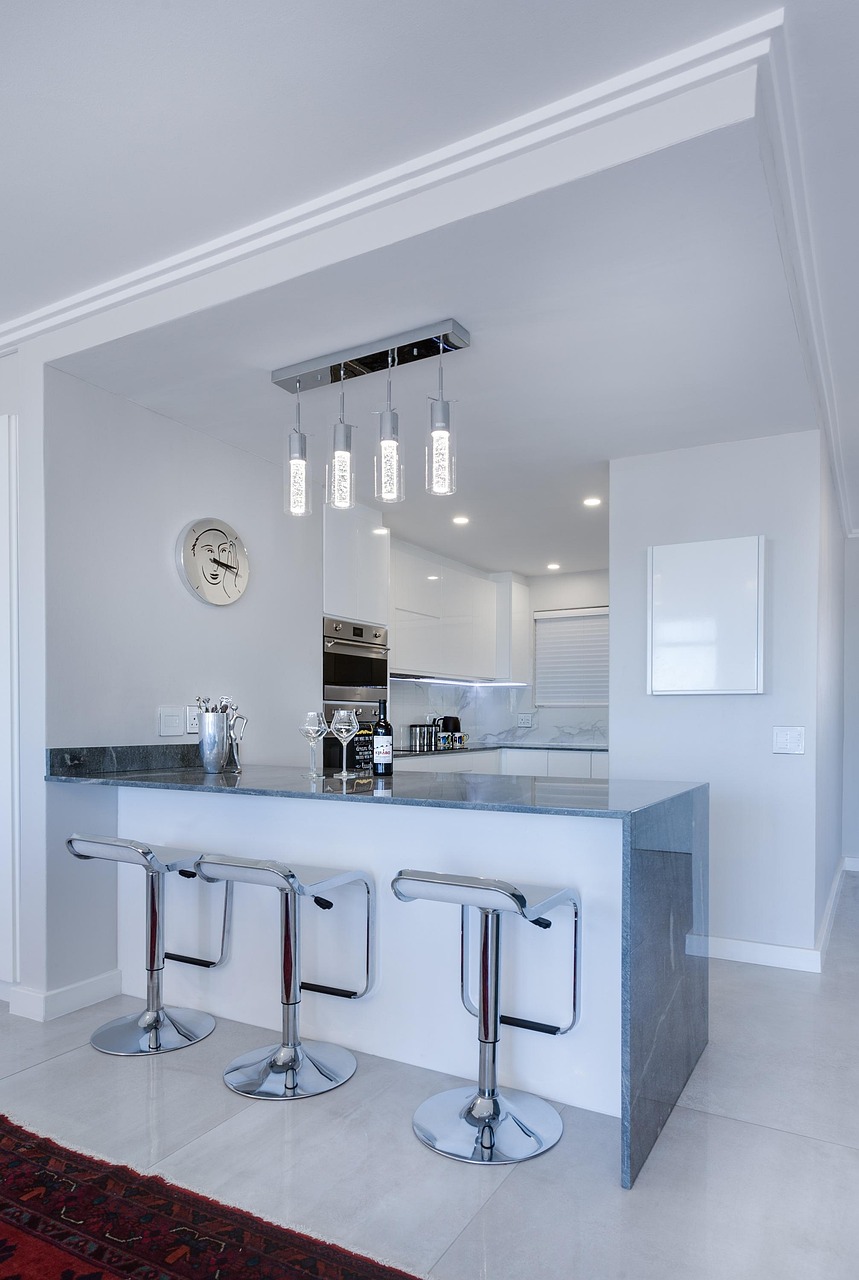 Minimalist small kitchen with handleless cabinets and an uncluttered countertop