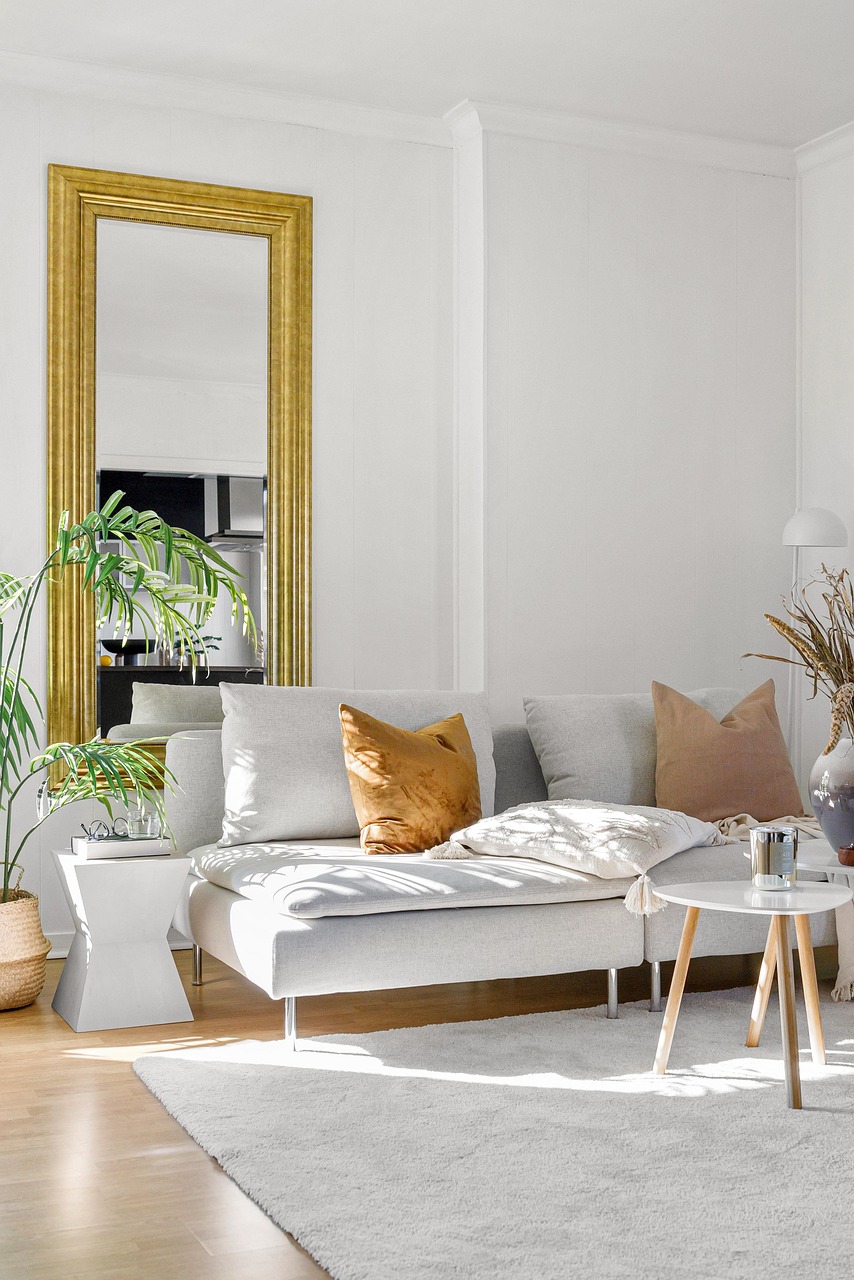 Living room with a cream sofa, warm wood accents and a low coffee table