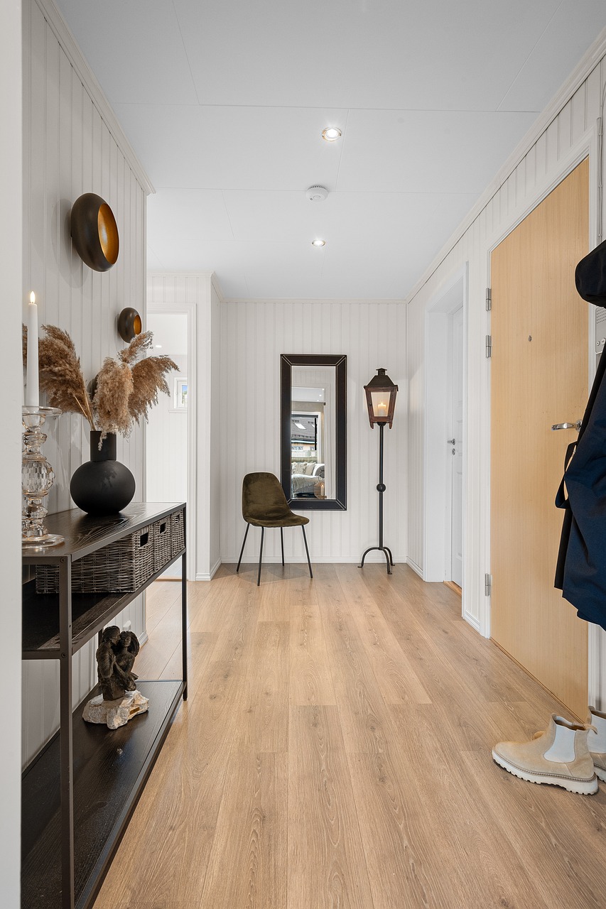 Hallway decorated with a row of framed art running along the wall